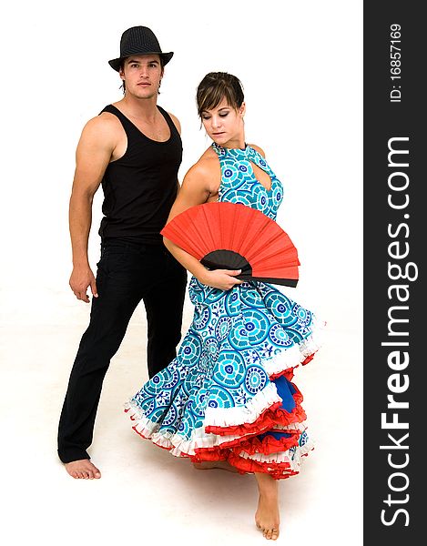 Young dancing couple posing wearing black red and blue clothing and female holding a red open Chinese fan. Young dancing couple posing wearing black red and blue clothing and female holding a red open Chinese fan