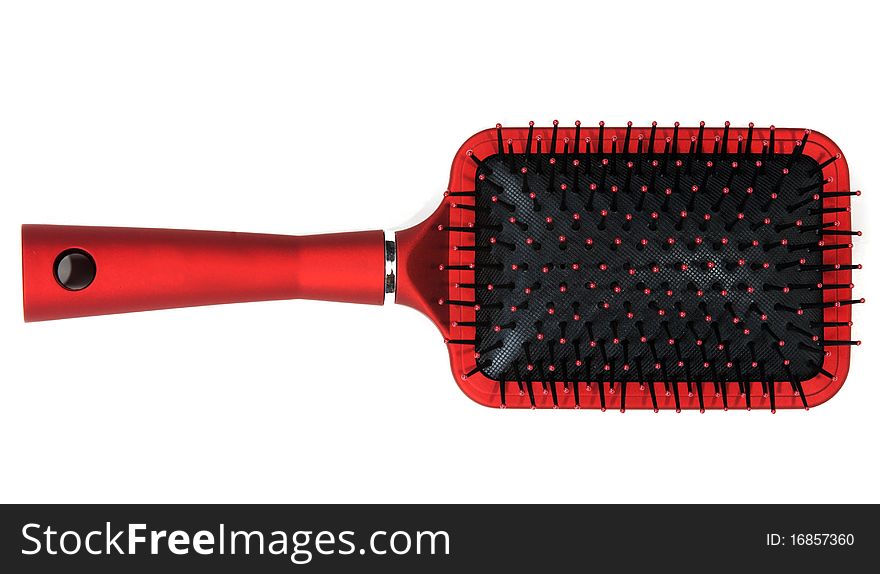 One red massages comb on white background