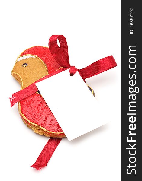 Illustrated Christmas cookies - a bird. Decorated cookies as a gift. A red ribbon tied white cardboard card.Isolated on a white background. Illustrated Christmas cookies - a bird. Decorated cookies as a gift. A red ribbon tied white cardboard card.Isolated on a white background.