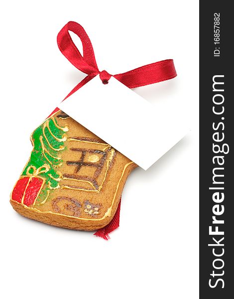 Illustrated Christmas cookies - a house. Decorated cookies as a gift. A red ribbon tied white cardboard card.Isolated on a white background. Illustrated Christmas cookies - a house. Decorated cookies as a gift. A red ribbon tied white cardboard card.Isolated on a white background.