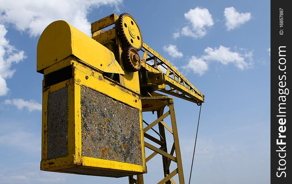 Old and rusty yellow crane in the harbour. Old and rusty yellow crane in the harbour