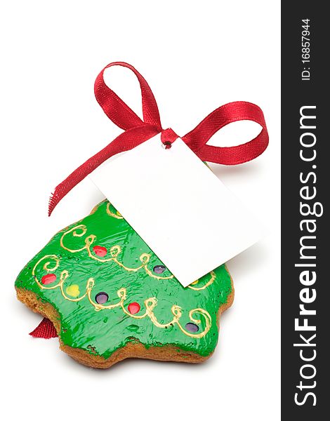 Illustrated Christmas cookies - a Christmas tree. Decorated cookies as a gift. A red ribbon tied white cardboard card.Isolated on a white background. Illustrated Christmas cookies - a Christmas tree. Decorated cookies as a gift. A red ribbon tied white cardboard card.Isolated on a white background.