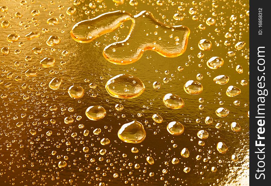 Water drops on golden surface