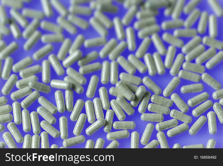 Large grouping of pills on blue background
