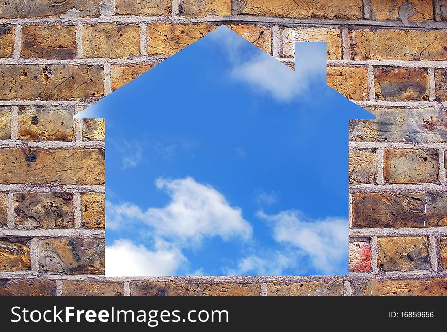 Hole in a brick wall in the shape of a house