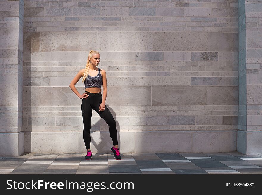 Attractive woman in sportswear training outdoor. Sport, jogging, healthy and active lifestyle concept.