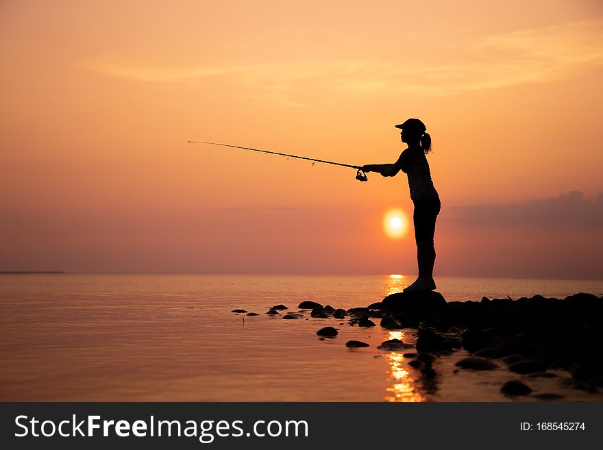 Woman fishing on Fishing rod spinning in Norway
