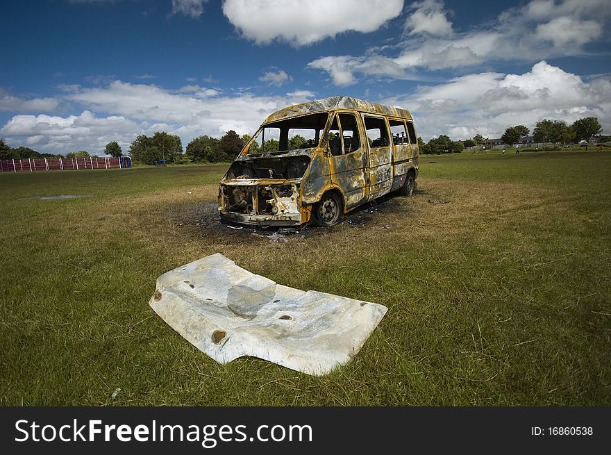 A stolen van, found burnt out on a playing field.