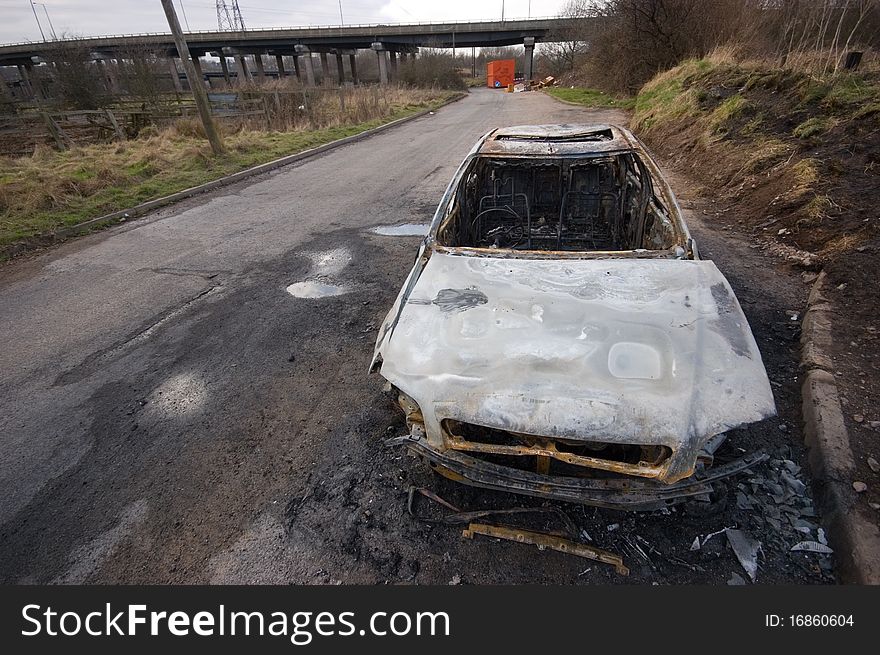 A stolen car, found burnt out in a side street. Taken with a wide angle lens.