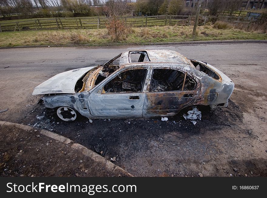 A stolen car, found burnt out in a side street. Taken with a wide angle lens.