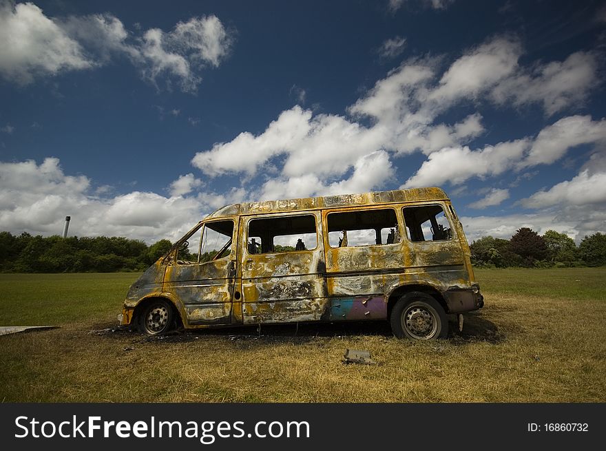 A stolen van, found burnt out on a playing field street. Taken early morning & with a polariser filter.