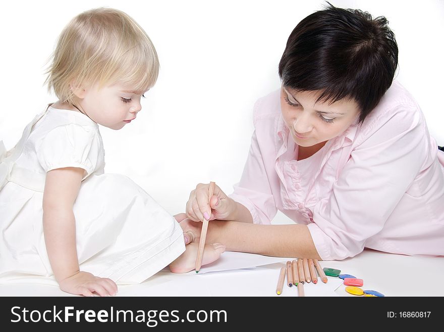 Mother and daughter painting together over white. Mother and daughter painting together over white