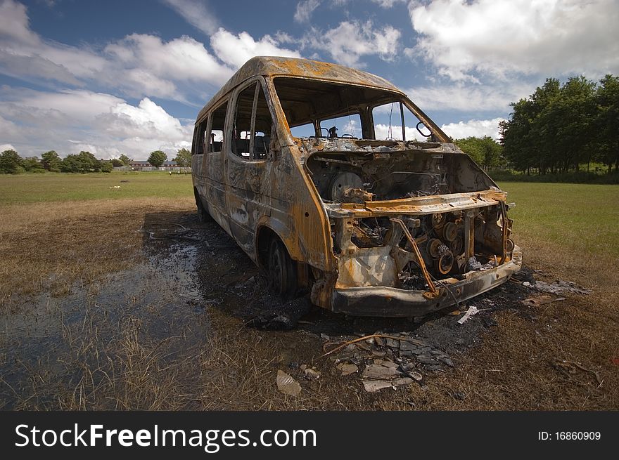 A stolen van, found burnt out on a playing field street. Taken early morning & with a polariser filter.