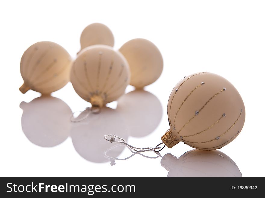 Five beige christmas balls with ornament