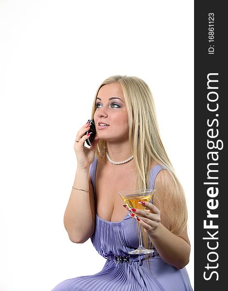Luxuriously young blond woman drink Martini and speak phone. Luxuriously young blond woman drink Martini and speak phone