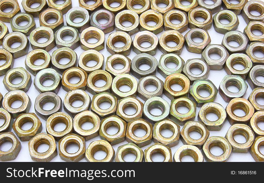 Small metal nuts on a white background a structure