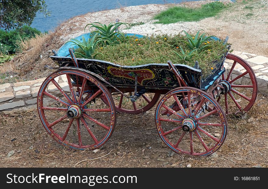 Old wooden cart full of flowers . Old wooden cart full of flowers .