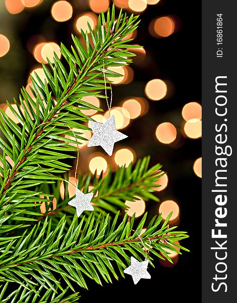 Fir branch with hanging Christmas decorations on a black background. Back background bokhe not photoshop. Fir branch with hanging Christmas decorations on a black background. Back background bokhe not photoshop.