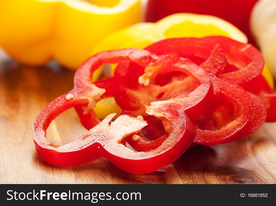 Fresh red and yellow peppers sliced into rings with garlic