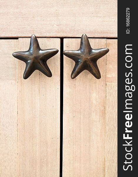 Star shape cabinet handles on wooden cabinet