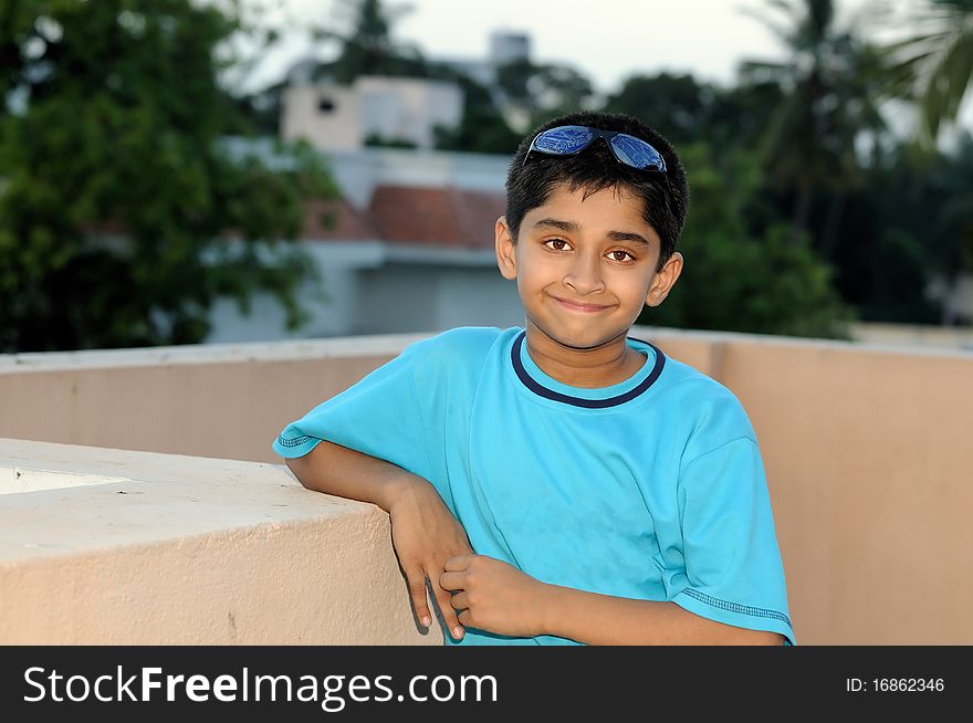 An handsome young Indian kid looking very happy