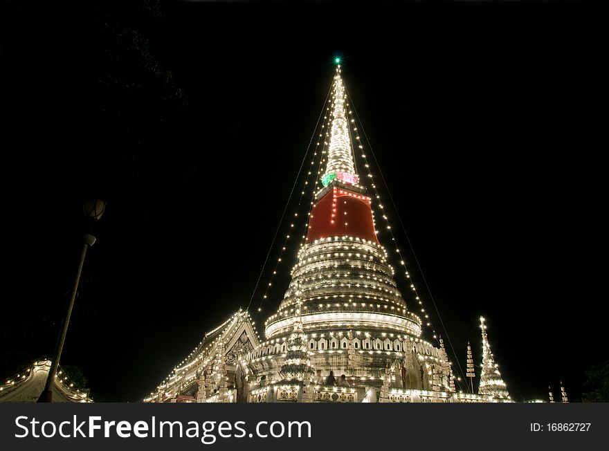 The stupa at Phra Samut Chedi in Samut Prakan, Thailand, decorated during a temple festival. People in the photo blurred due to long exposure. The stupa at Phra Samut Chedi in Samut Prakan, Thailand, decorated during a temple festival. People in the photo blurred due to long exposure.