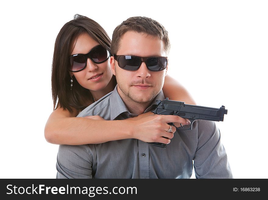 Woman with a gun and the man in sun glasses closeup. Woman with a gun and the man in sun glasses closeup