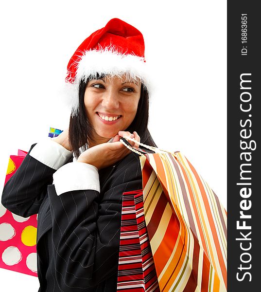 Smiling young businesswoman in santa hat with shopping bags. Smiling young businesswoman in santa hat with shopping bags