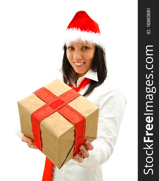 Smiling young woman with santa hat and red tie offers a gift to us. Smiling young woman with santa hat and red tie offers a gift to us