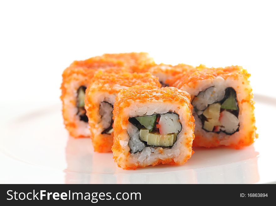 Egg imitation crabmeat cucumber tuna and salmon roll sushi in macro with white background. Egg imitation crabmeat cucumber tuna and salmon roll sushi in macro with white background