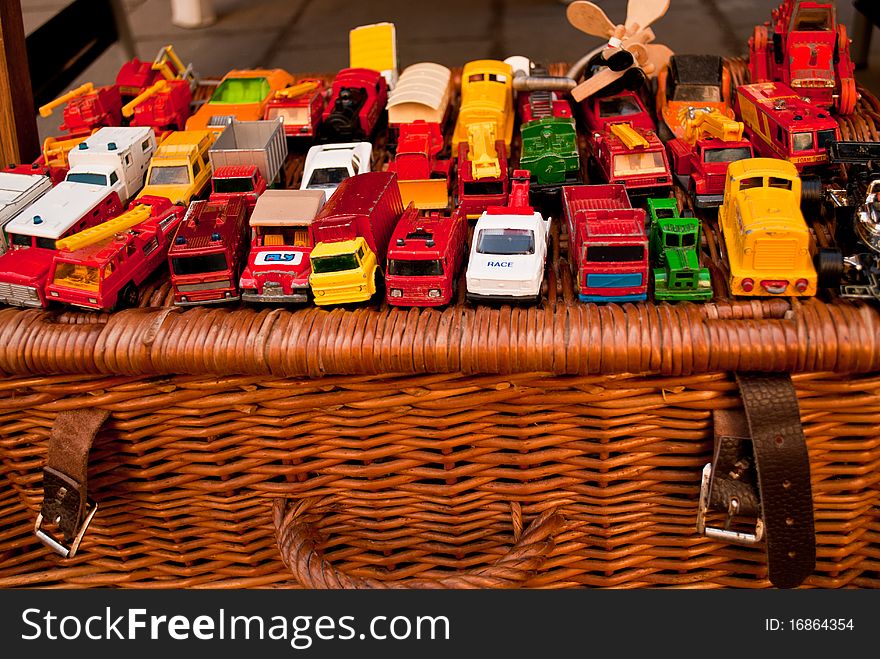 Colorful toy cars on top of a wicker basket