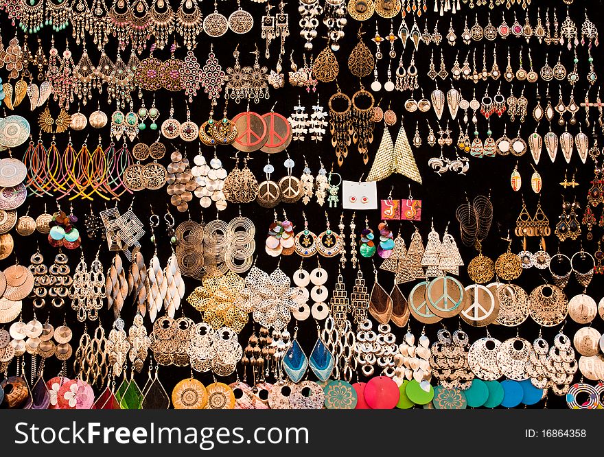 Lots of jewelry for sale on a stand. Lots of jewelry for sale on a stand