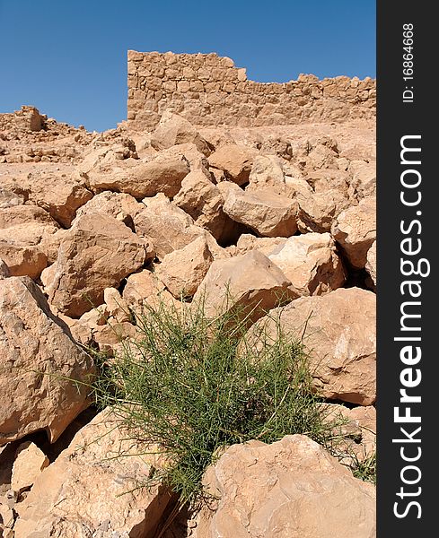 Ruins of ancient tower on the rocky hill in Masada fortress in Israel