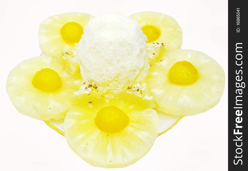 Vanilla ice-cream scoop with pineapple slices in syrup. Vanilla ice-cream scoop with pineapple slices in syrup