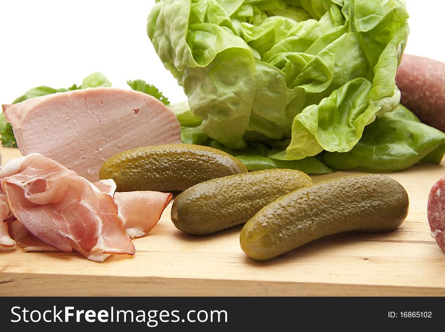 Raw ham with gherkin and salad