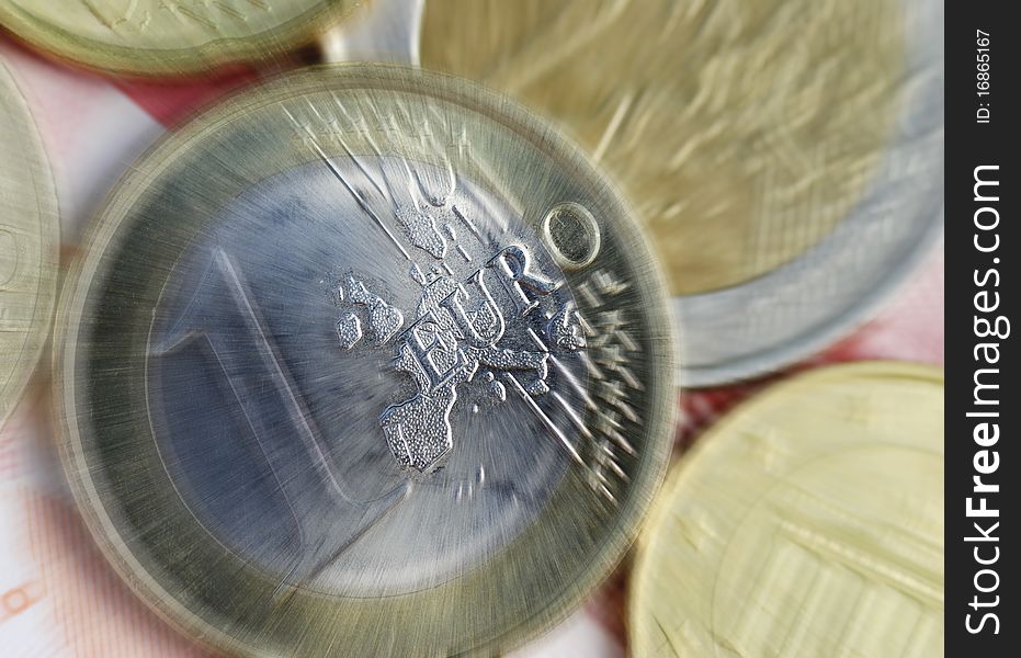 Euro coins resting on banknotes with zoom effect. Euro coins resting on banknotes with zoom effect