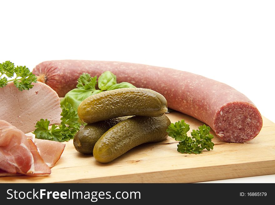 Raw ham and salami with gherkins