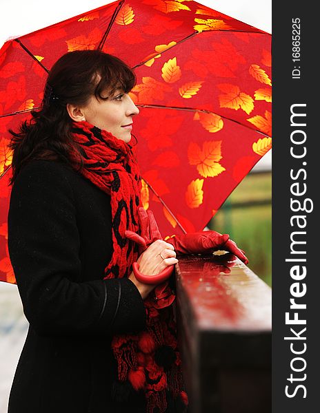 The beautiful girl with a red umbrella.