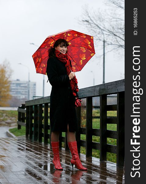 The beautiful girl with a red umbrella.