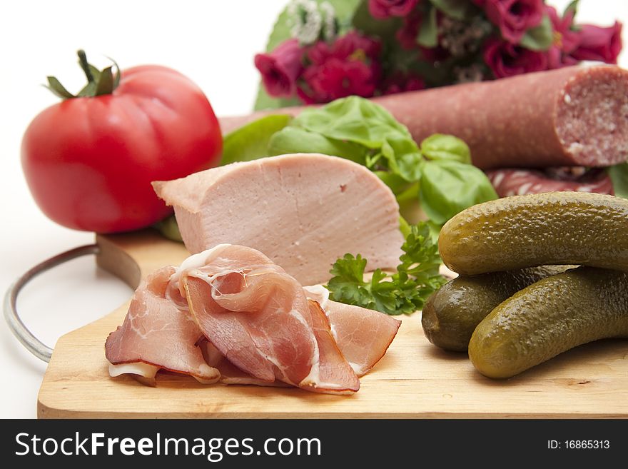 Raw ham with gherkins and tomato