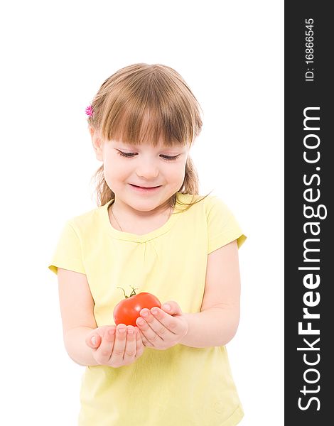 The portrait of a cute little girl holding a red tomato in her hands