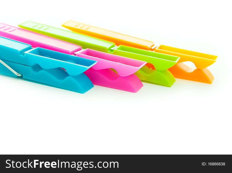 Close up shot of multicolored clothespins isolated on white