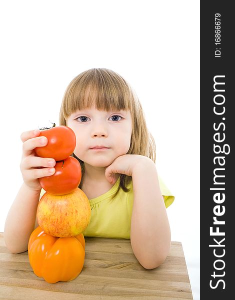 The portrait of a cute little girl holding fresh vegetables