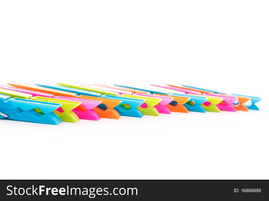 Close up shot of multicolored clothespins isolated on white