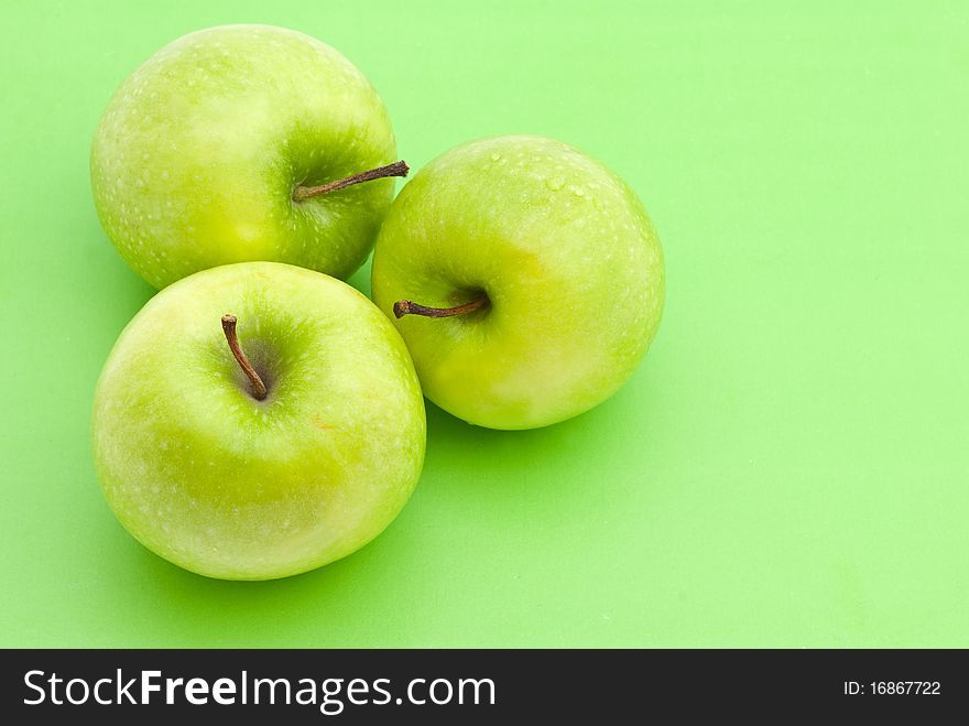 Green apples on the green background