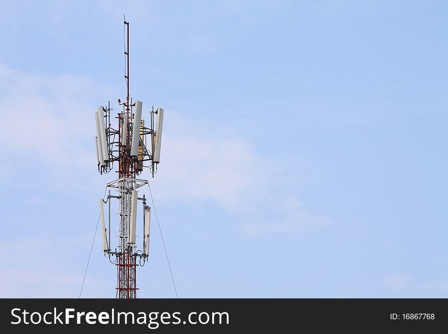 Top of a telecommunication tower with blue sky