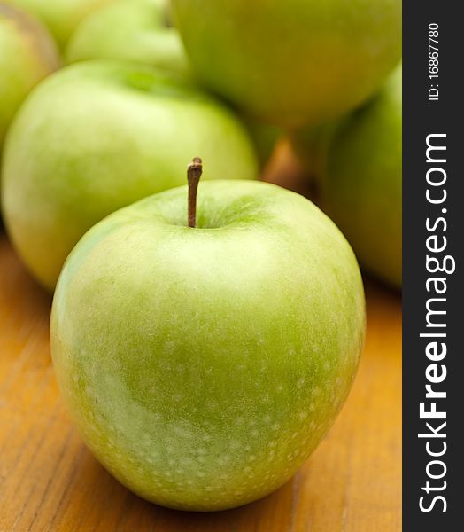 Green apples on the wood background