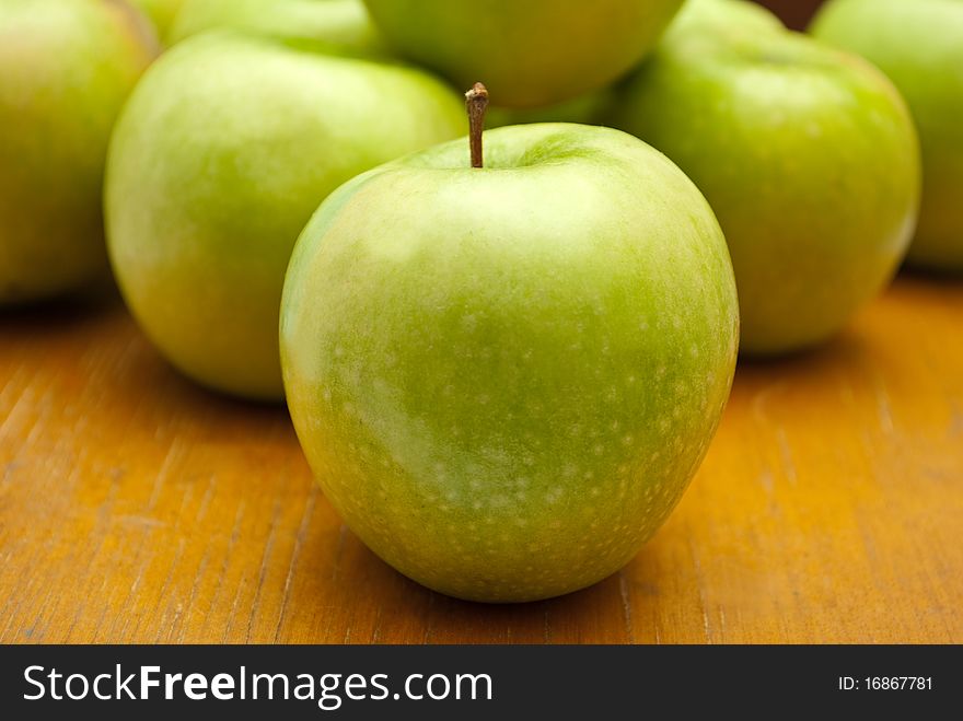 Green apples on the wood background