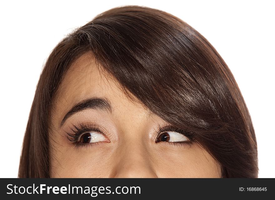 Closeup of young brunette with brown eyes looking to her right, in an expression of thoughtfulness. Closeup of young brunette with brown eyes looking to her right, in an expression of thoughtfulness.