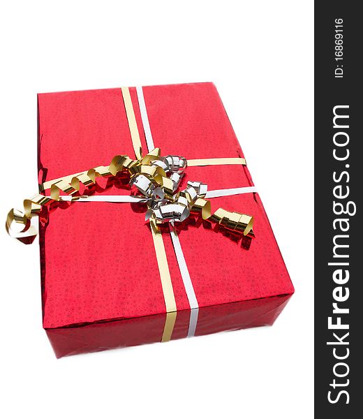 Red gift box wrapped with gold ribbon and bow.